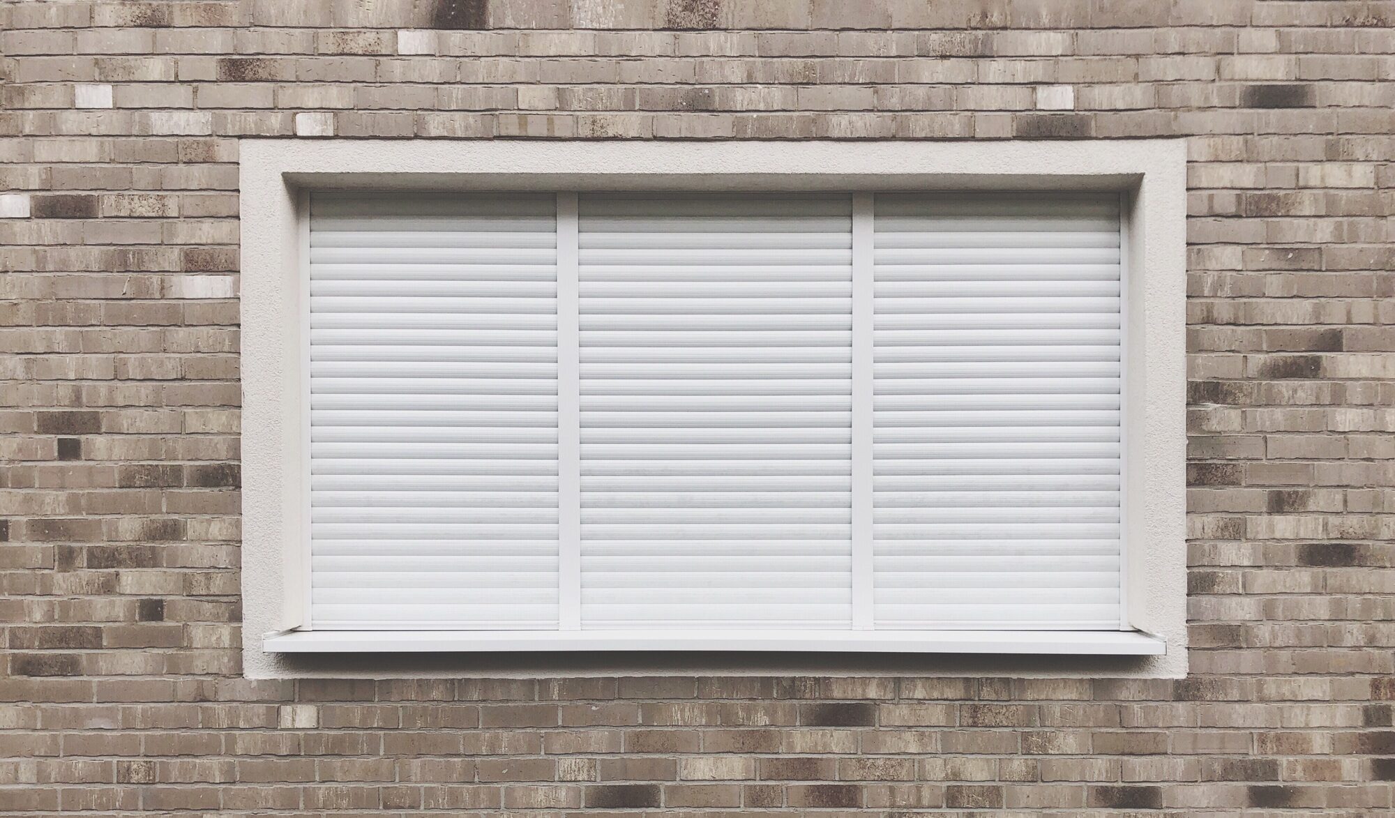 Window with closed roller shutter blinds